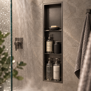 Ana wall niche, 36 × 8 in, black PVD, recessed in a shower wall, bottles and soap stored inside