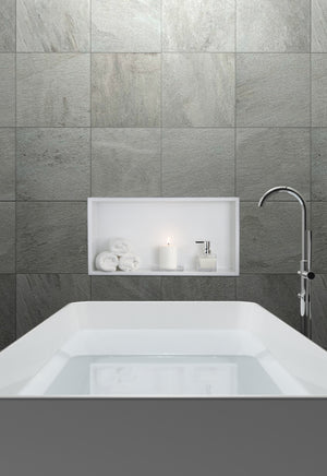 Andy wall niche, 12 × 24 in, matte white, in a gray tile wall above a tub and a freestanding faucet