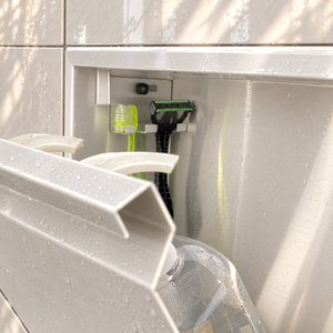 Close-up of the inside of the door niche, 12 × 24 in door, glossy white: hooks holding a razor, a toothbrush and a bottle