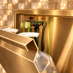 Close-up of the inside of the door niche, 12 × 24 in door, gold PVD: hooks holding a razor, a toothbrush and a bottle