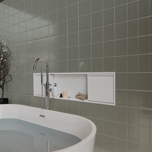 Door niche, 12 × 48 in, matte white, in a gray-green tiled wall above a freestanding tub, candle and towels inside