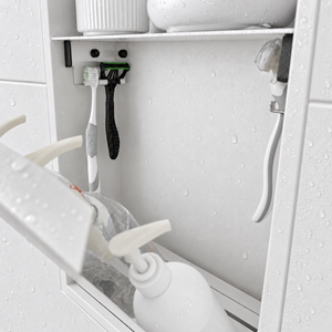 Close-up of the inside of the door niche, 24 × 12 in door, matte white: hooks holding a razor, a toothbrush and a bottle