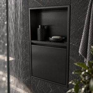 Door niche, 24 × 12 in, matte black, door closed, recessed in a bathroom wall