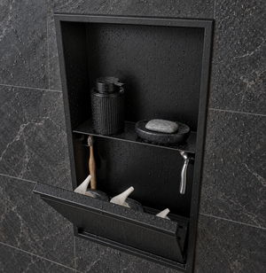 Door niche, 24 × 12 in, matte black, tilt-down door open: toiletries stored inside