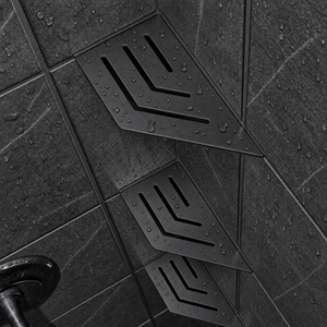 Corner shelf, 4 × 8 in, matte black, angled view, with two more shelves below, in a tiled shower