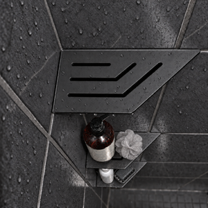 Corner shelf, 4 × 8 in, matte black, bottle and shower puff on the lower shelves, in a tiled shower
