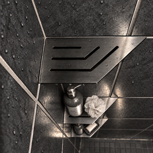 Corner shelf, 4 × 8 in, black PVD, bottle and shower puff on the lower shelves, in a tiled shower