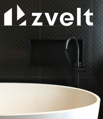 Logotype Zvelt au-dessus d’une niche encastrée vide dans un mur de tuiles noires, près d’un robinet de baignoire sur colonne
