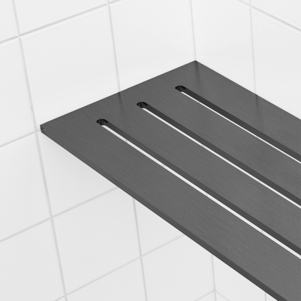 Black PVD, brushed gunmetal seen close up, the 4 × 8 in corner shelf standing out against white tile.