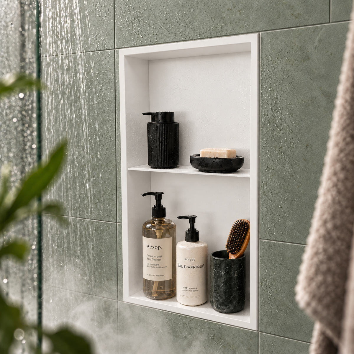 Acia wall niche, 24 × 12 in, matte white, recessed in a shower wall, bottles and soap stored inside