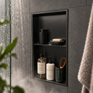 Acia wall niche, 24 × 12 in, matte black, recessed in a shower wall, bottles and soap stored inside