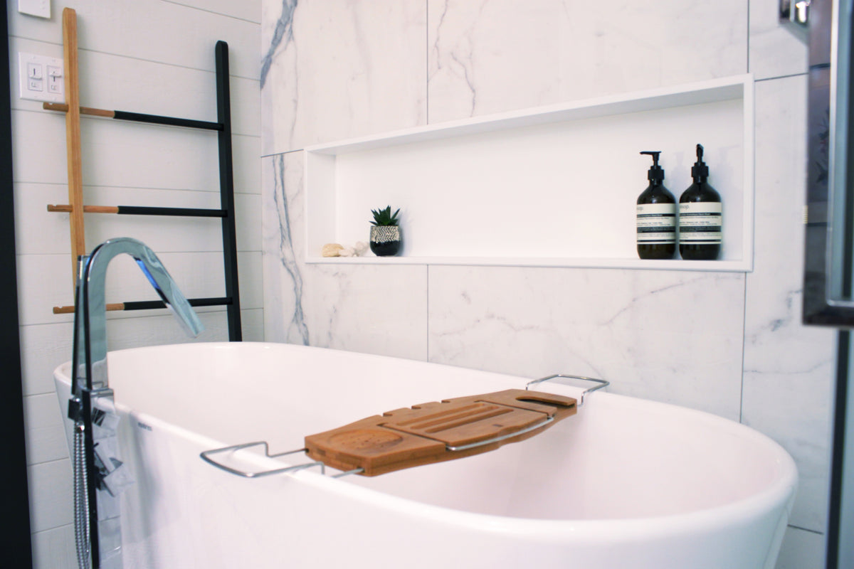 Alba wall niche, 12 × 48 in, matte white, in a white marble wall above a freestanding tub and its wooden tray