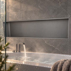 Alba wall niche, 12 × 48 in, matte gray, recessed in a wall above a bathtub, empty