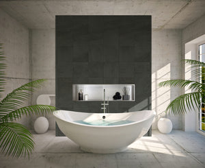 Alba wall niche, 12 × 48 in, brushed stainless steel, in a dark tile wall behind an oval tub surrounded by plants
