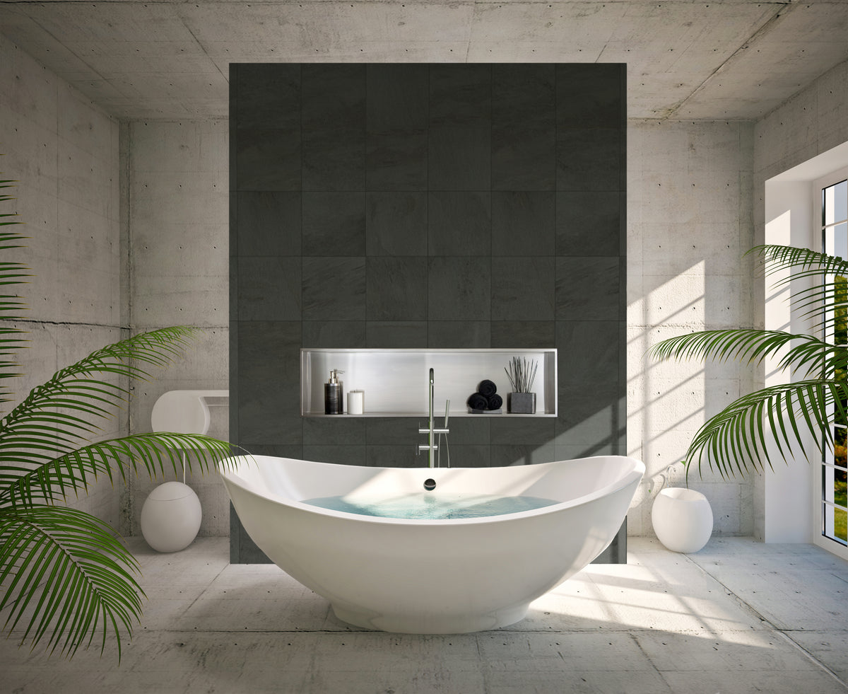 Alba wall niche, 12 × 48 in, brushed stainless steel, in a dark tile wall behind an oval tub surrounded by plants
