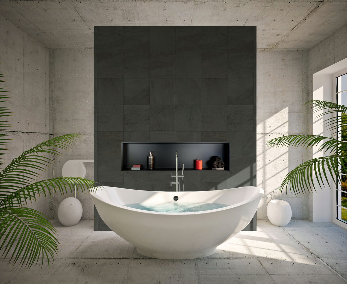 Alba wall niche, 12 × 48 in, matte black, in a dark tile wall behind an oval tub surrounded by plants