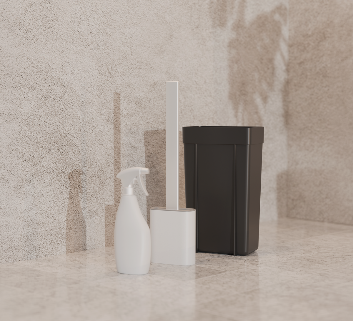 Vaporisateur et brosse blancs, poubelle noire : les accessoires livrés avec la niche WC, au sol carrelé, gros plan