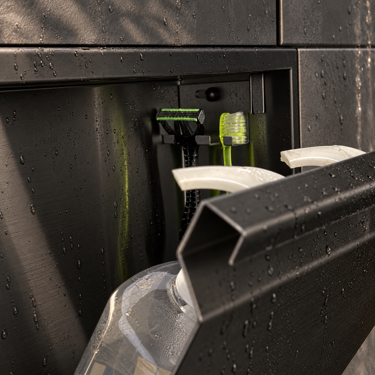 Close-up of the inside of the door niche, 12 × 12 in door, matte black: hooks holding a razor, a toothbrush and a bottle