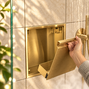 A hand lifts the removable door off the door niche, 12 × 12 in, gold PVD