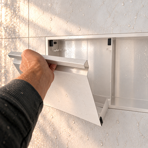A hand lifts the removable door off the door niche, 12 × 24 in, glossy white