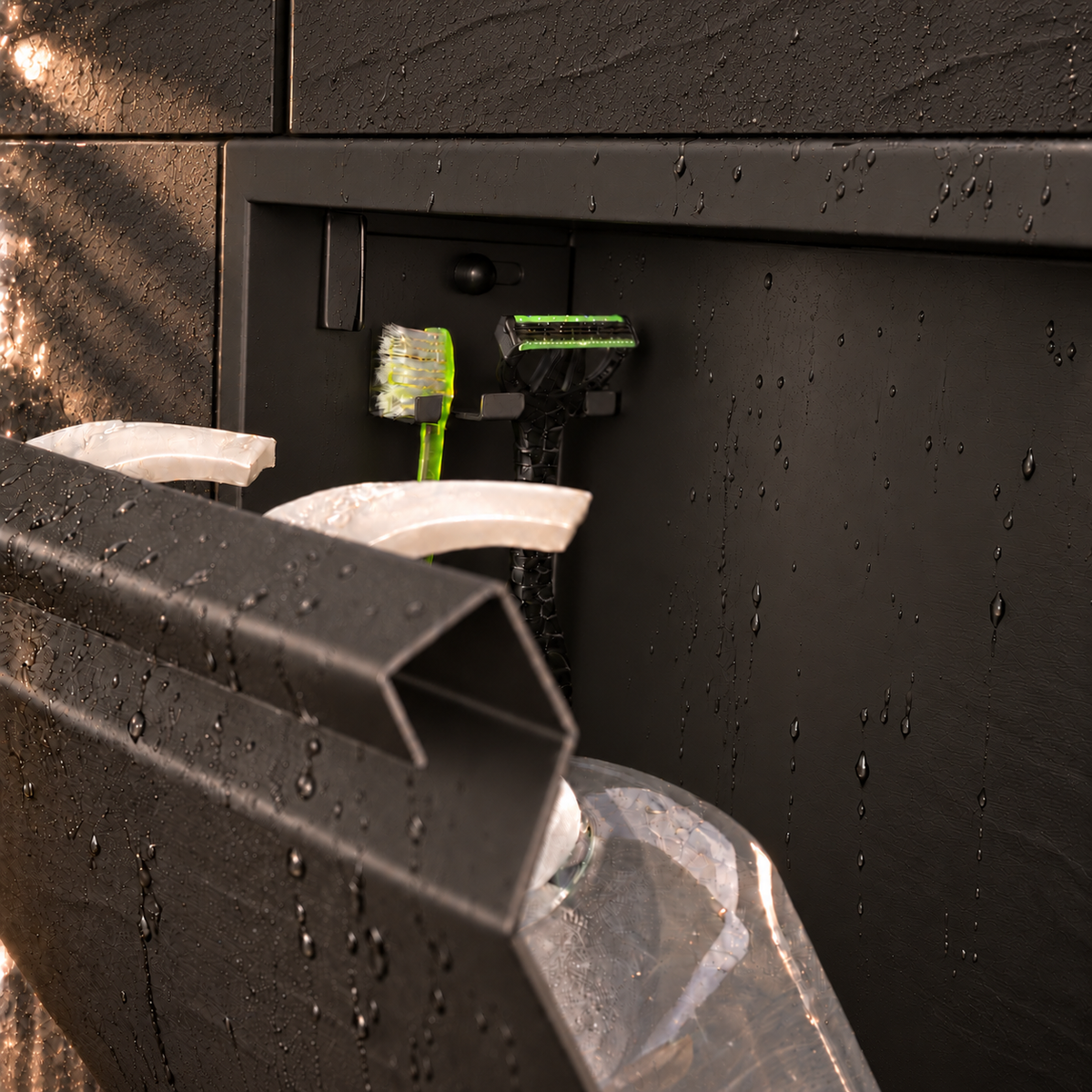Close-up of the inside of the door niche, 12 × 24 in door, matte black: hooks holding a razor, a toothbrush and a bottle