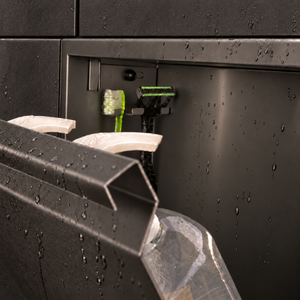 Close-up of the inside of the door niche, 12 × 24 in door, black PVD: hooks holding a razor, a toothbrush and a bottle