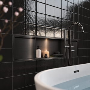 Door niche, 12 × 48 in, black PVD, door closed, recessed in a bathroom wall