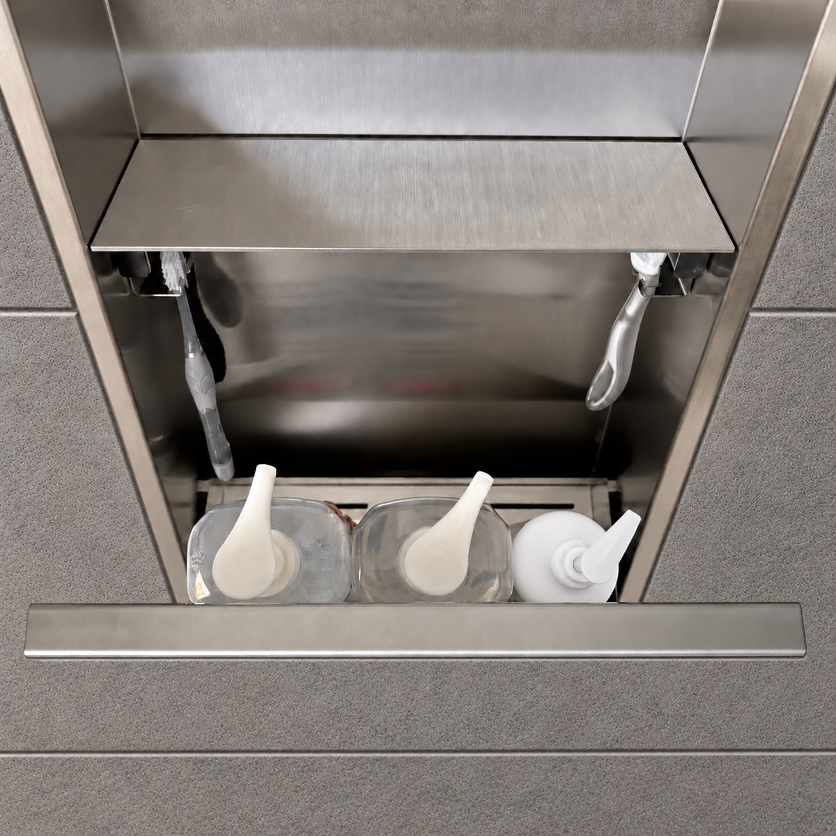 Inside view of the door niche, 24 × 12 in, brushed stainless steel, door open: bottles stored in the compartment