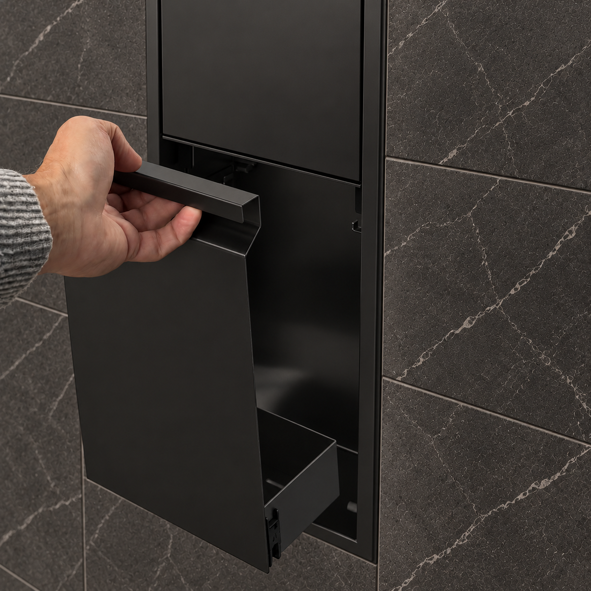 A hand lifts the removable door off the door niche, 36 × 8 in, matte black