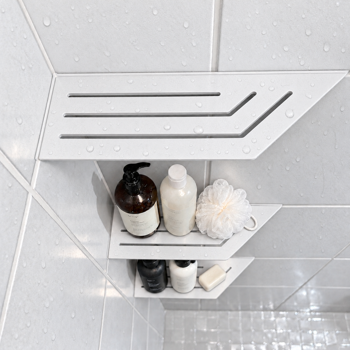 Corner shelf, 4 × 12 in, matte white, bottles and a shower puff on the lower shelves, in a tiled shower