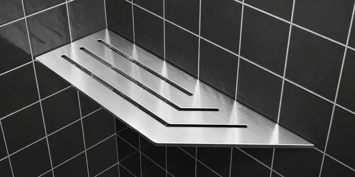 Corner shelf, 4 × 12 in, brushed stainless steel, mounted in the corner of a tiled wall