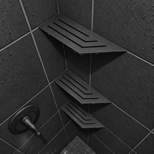 Corner shelf, 4 × 12 in, matte black, in the corner of a tiled shower, two smaller shelves below