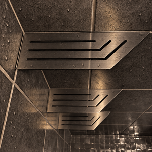 Corner shelf, 4 × 12 in, black PVD, close view, with the two smaller shelves below, in a tiled shower