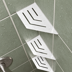 Corner shelf, 4 × 8 in, glossy white, angled view, with two more shelves below, in a tiled shower