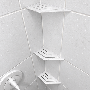 Corner shelf, 4 × 8 in, matte white, in the corner of a tiled shower, two smaller shelves below