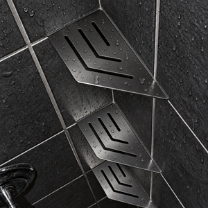 Corner shelf, 4 × 8 in, black PVD, angled view, with two more shelves below, in a tiled shower